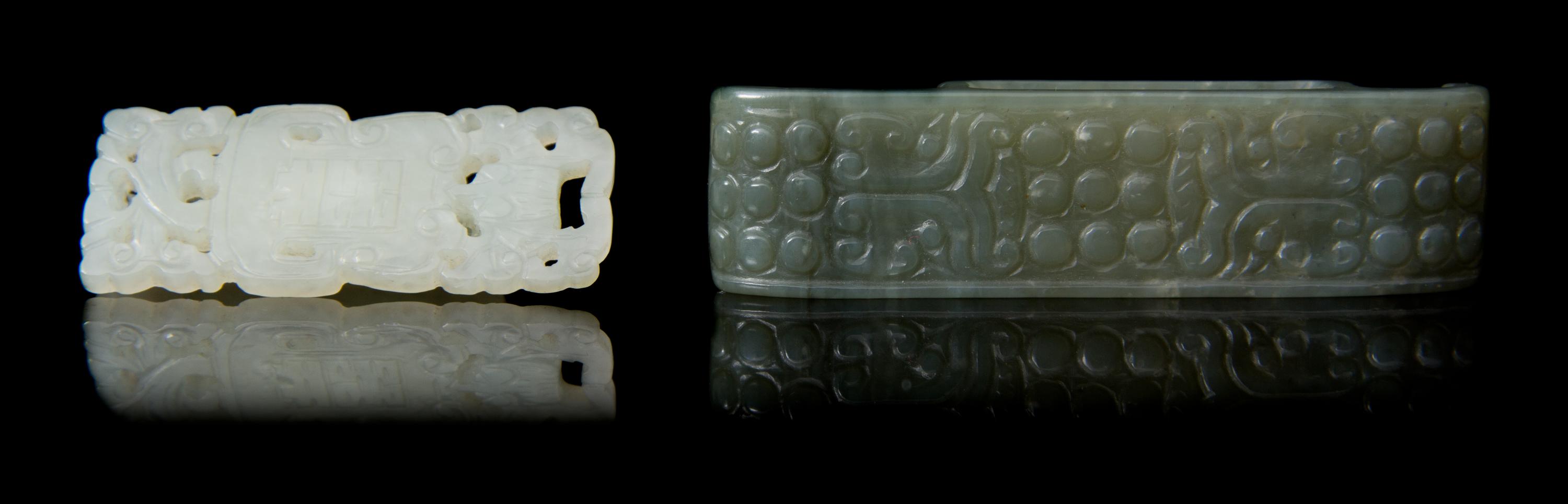 Two Carved Jade Sword Slides Length of larger 2 3/4 inches.