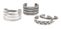 Four Southwestern Style Silver Cuff Bracelets Length of one 5 1/2 x opening 1 1/2 x width 1 5/8 inches