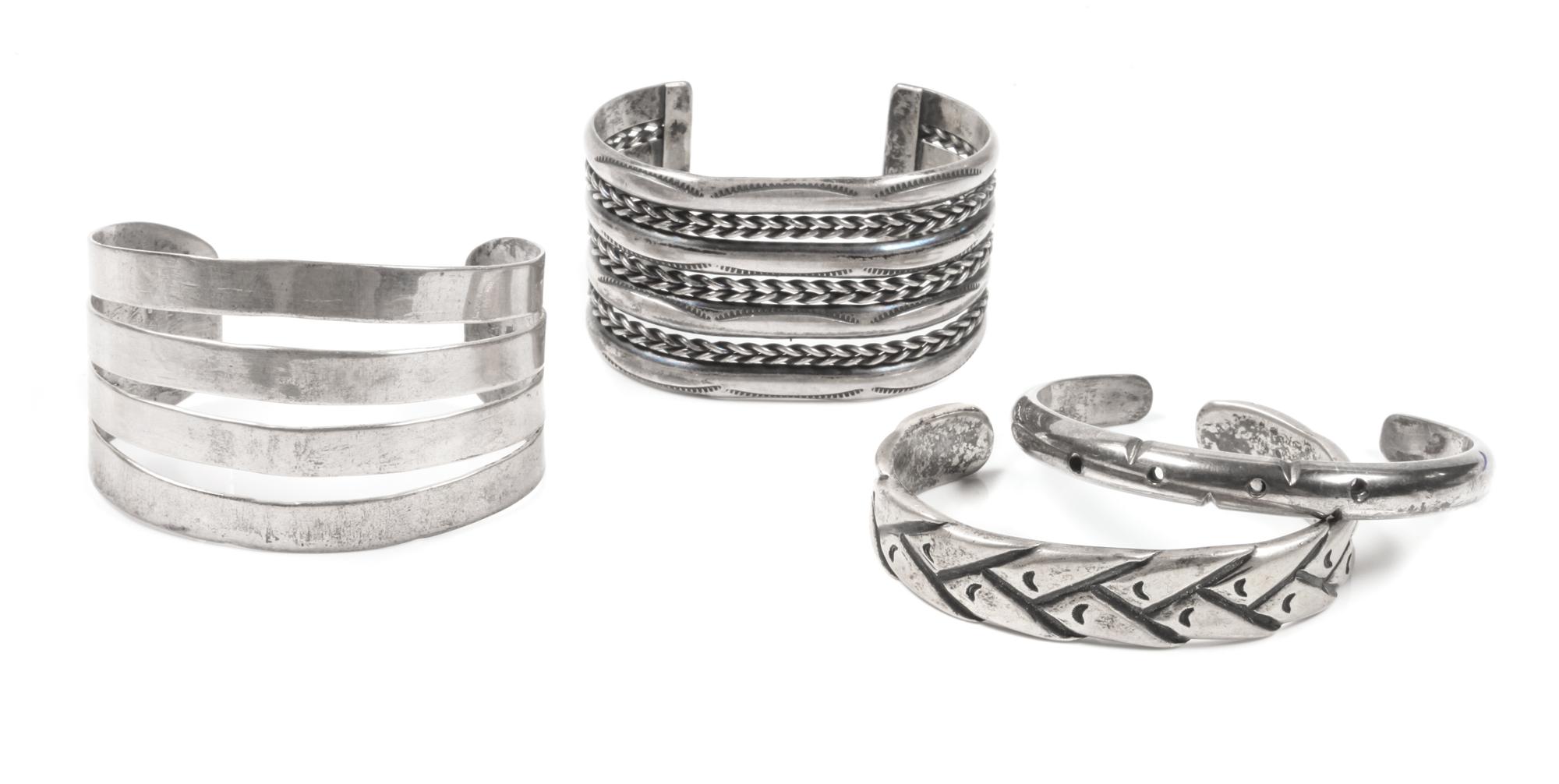Four Southwestern Style Silver Cuff Bracelets Length of one 5 1/2 x opening 1 1/2 x width 1 5/8 inches