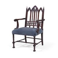 A Gothic Revival Style Carved Oak Armchair