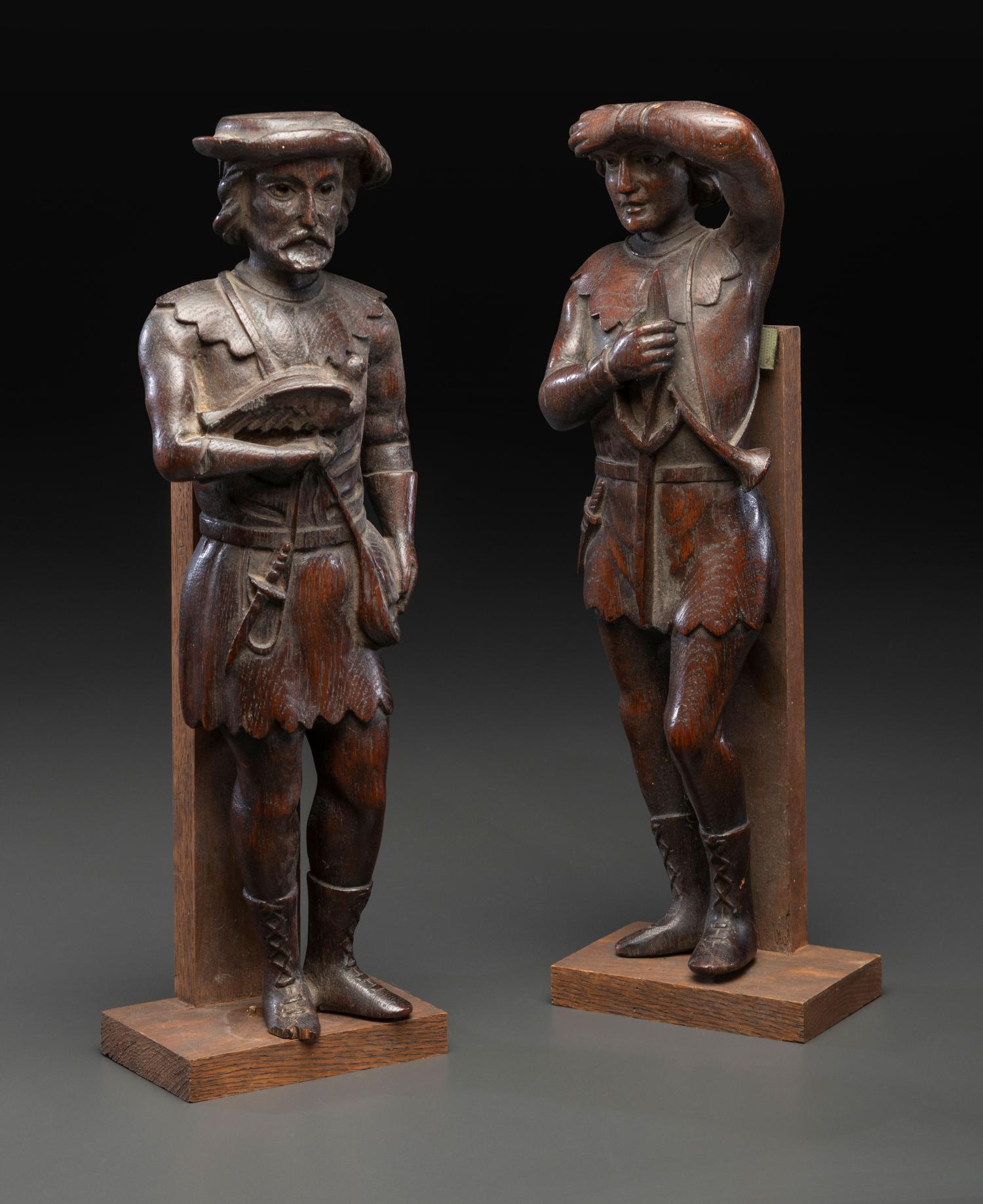 A Pair of Continental Carved Oak Huntsman Figures