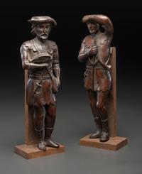 A Pair of Continental Carved Oak Huntsman Figures