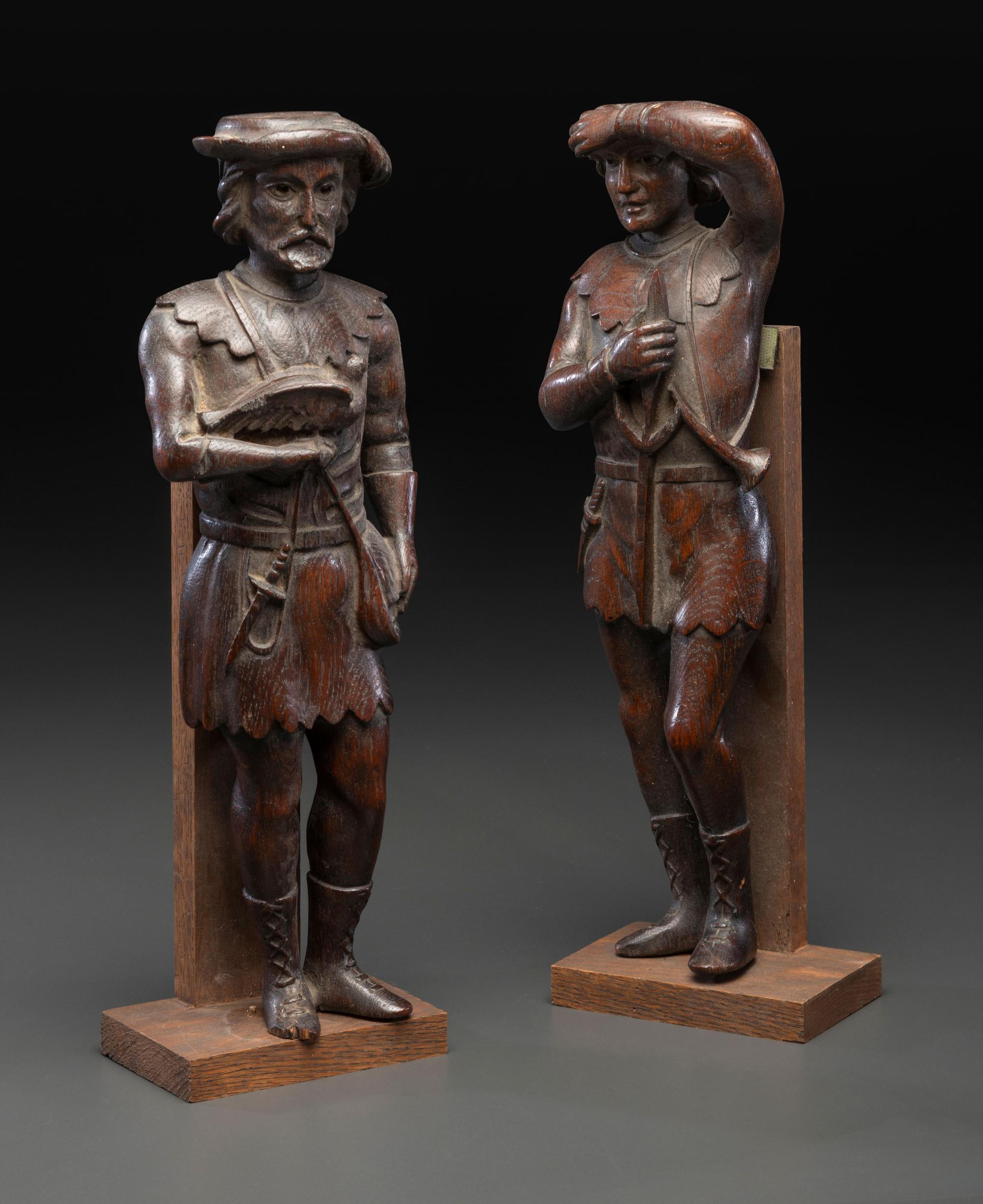 A Pair of Continental Carved Oak Huntsman Figures