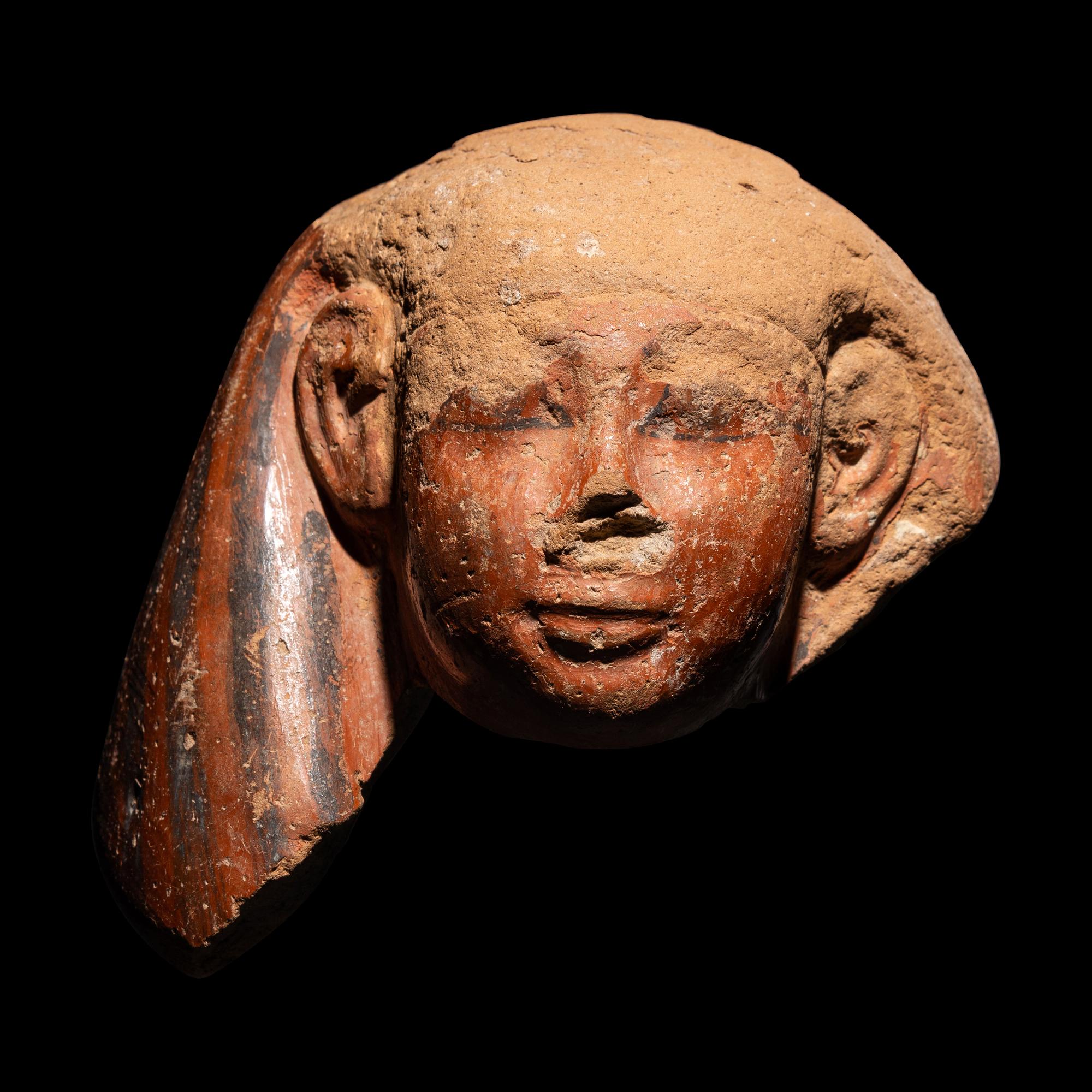 An Egyptian Polychrome Canopic Jar Lid