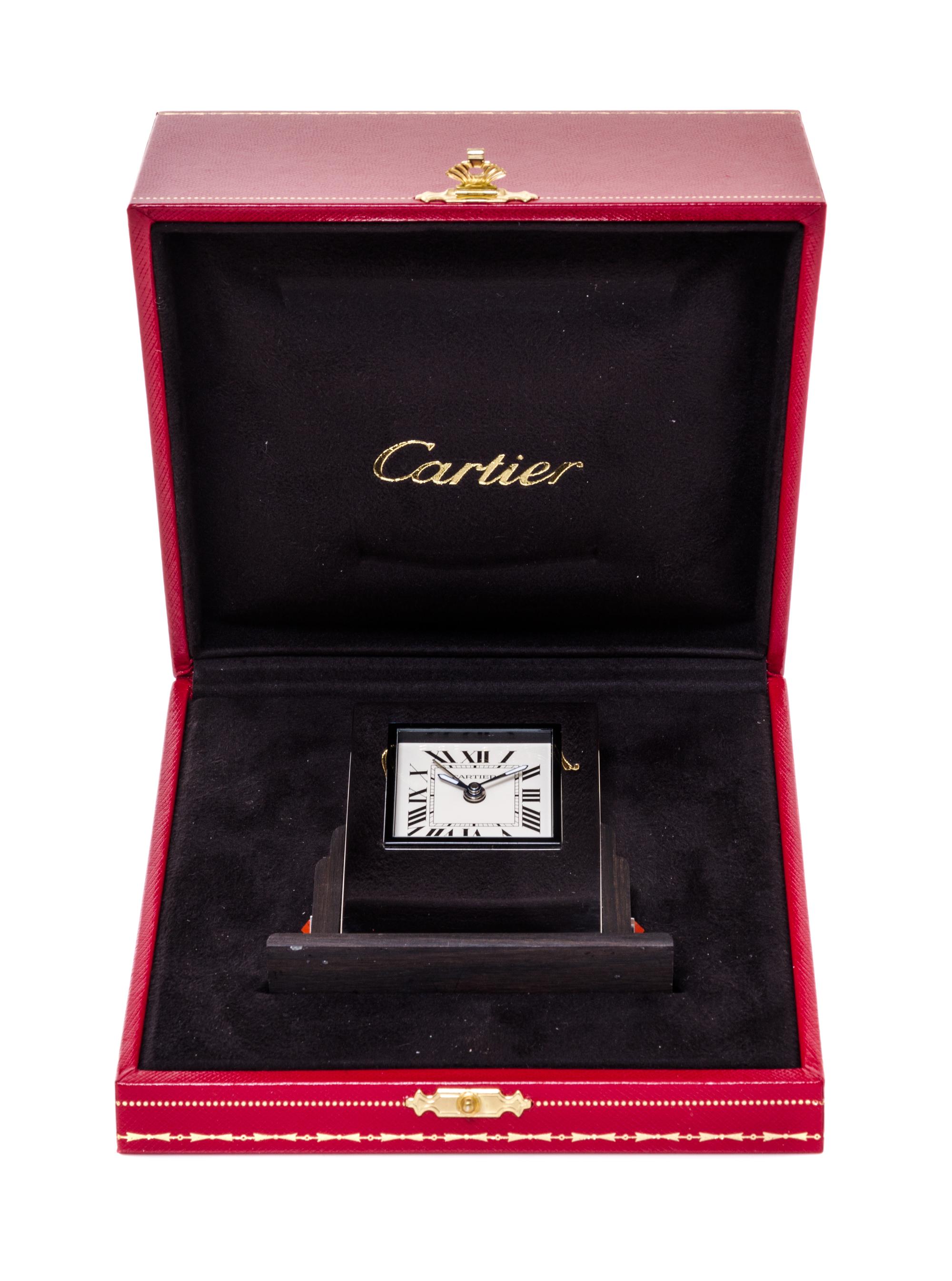 A Cartier Art Deco Style Travel Alarm Clock Height 3 1/2 x width 3 3/8 x depth 1 3/8 inches. — 20TH CENTURY