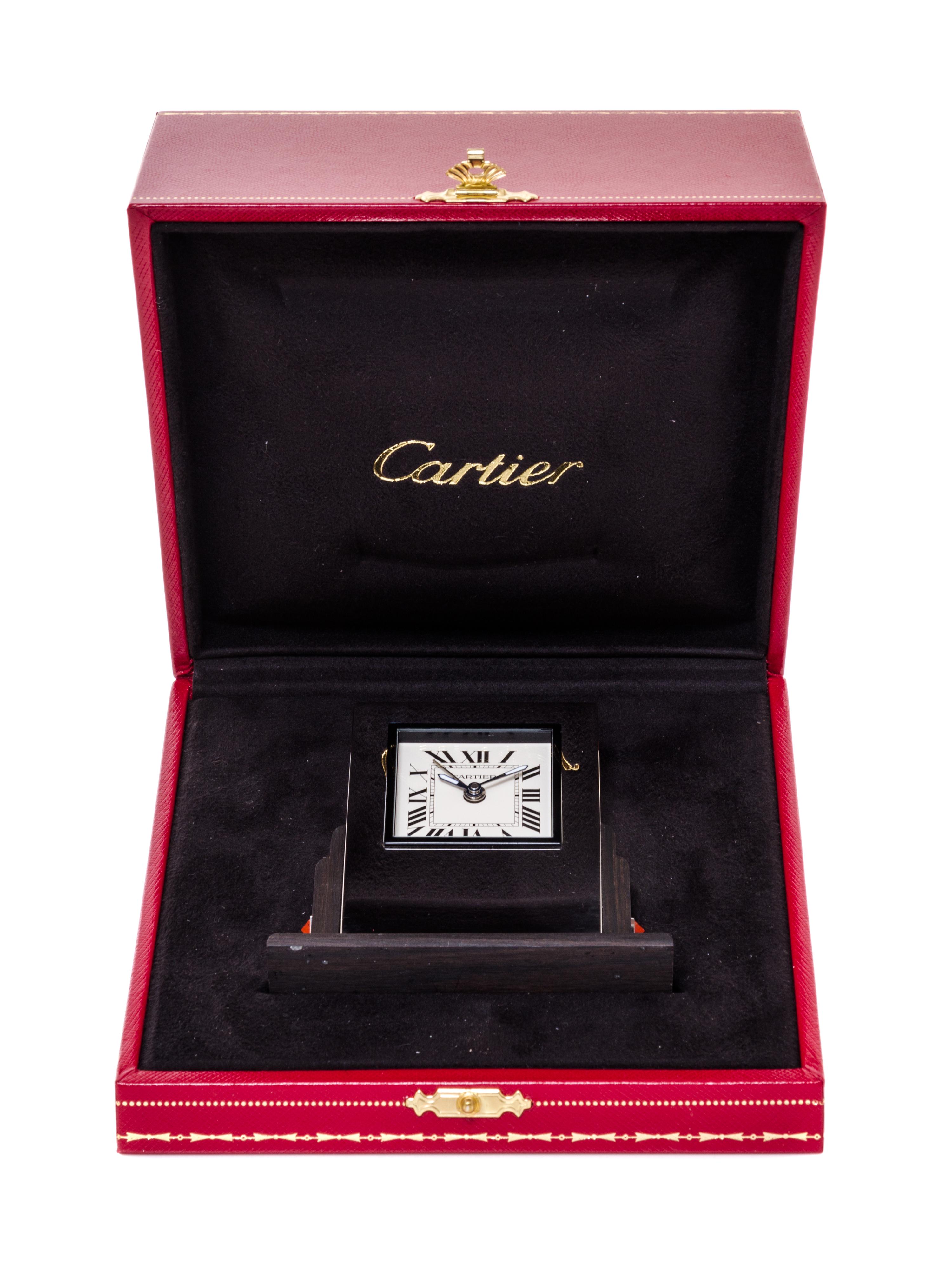 A Cartier Art Deco Style Travel Alarm Clock Height 3 1/2 x width 3 3/8 x depth 1 3/8 inches. — 20TH CENTURY