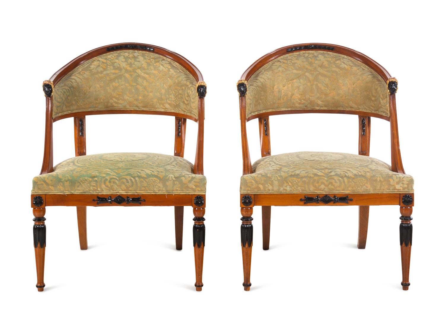A Pair of Empire Style Parcel Gilt and Ebonized Bergères