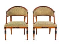 A Pair of Empire Style Parcel Gilt and Ebonized Bergères