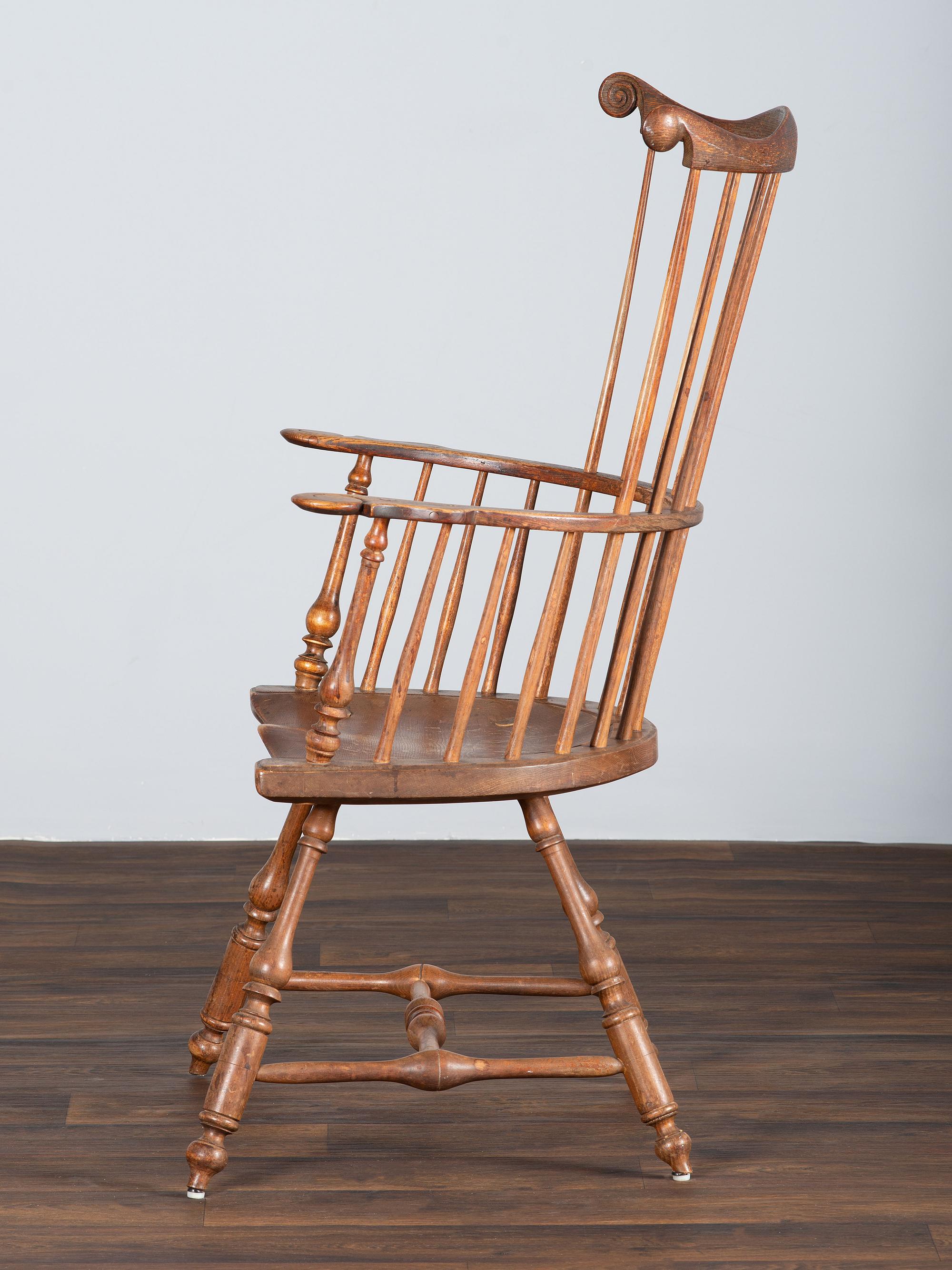 A Volute and Scroll Carved and Reel Turned Windsor Armchair
