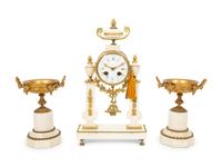 A French Gilt Bronze and Marble Mantel Clock with an Associated Pair of Urns