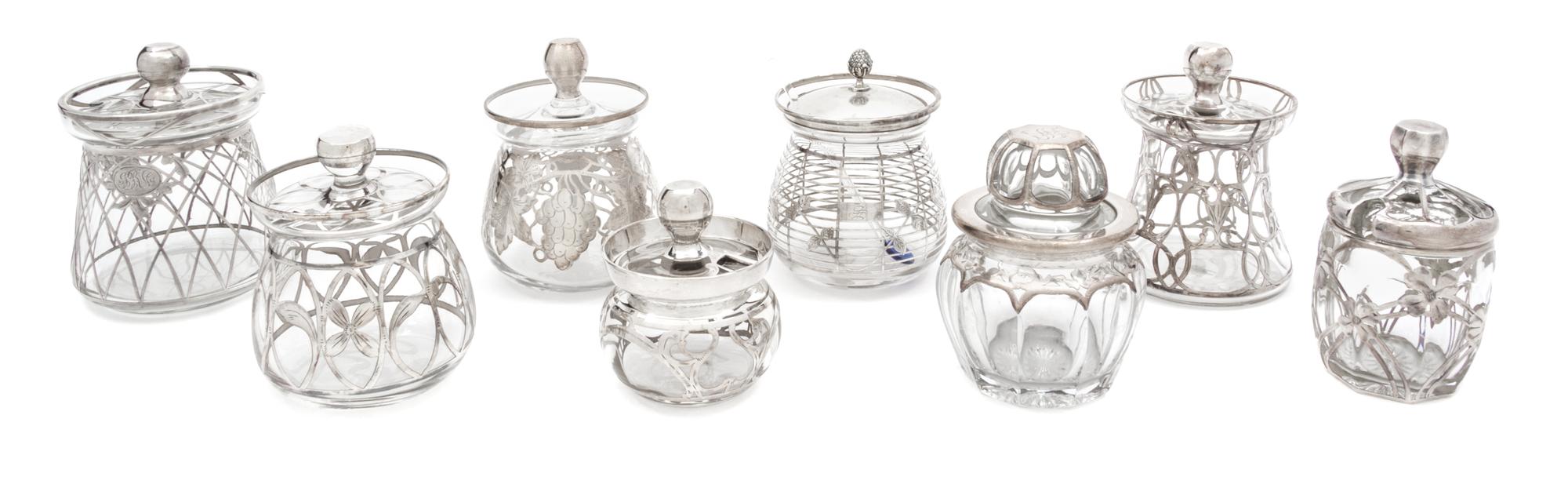 A Collection of Eight Silver Overlay Covered Jars Height of tallest 4 3/4 inches.