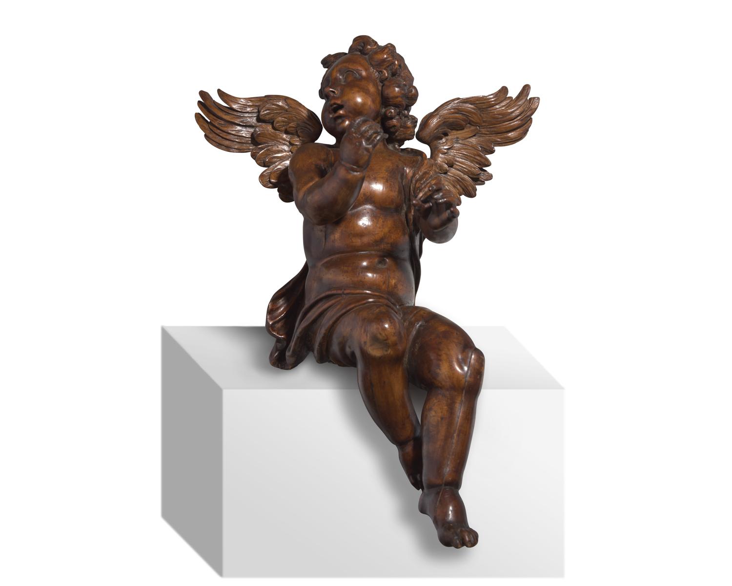 An Italian Baroque carved walnut angel, 17th century