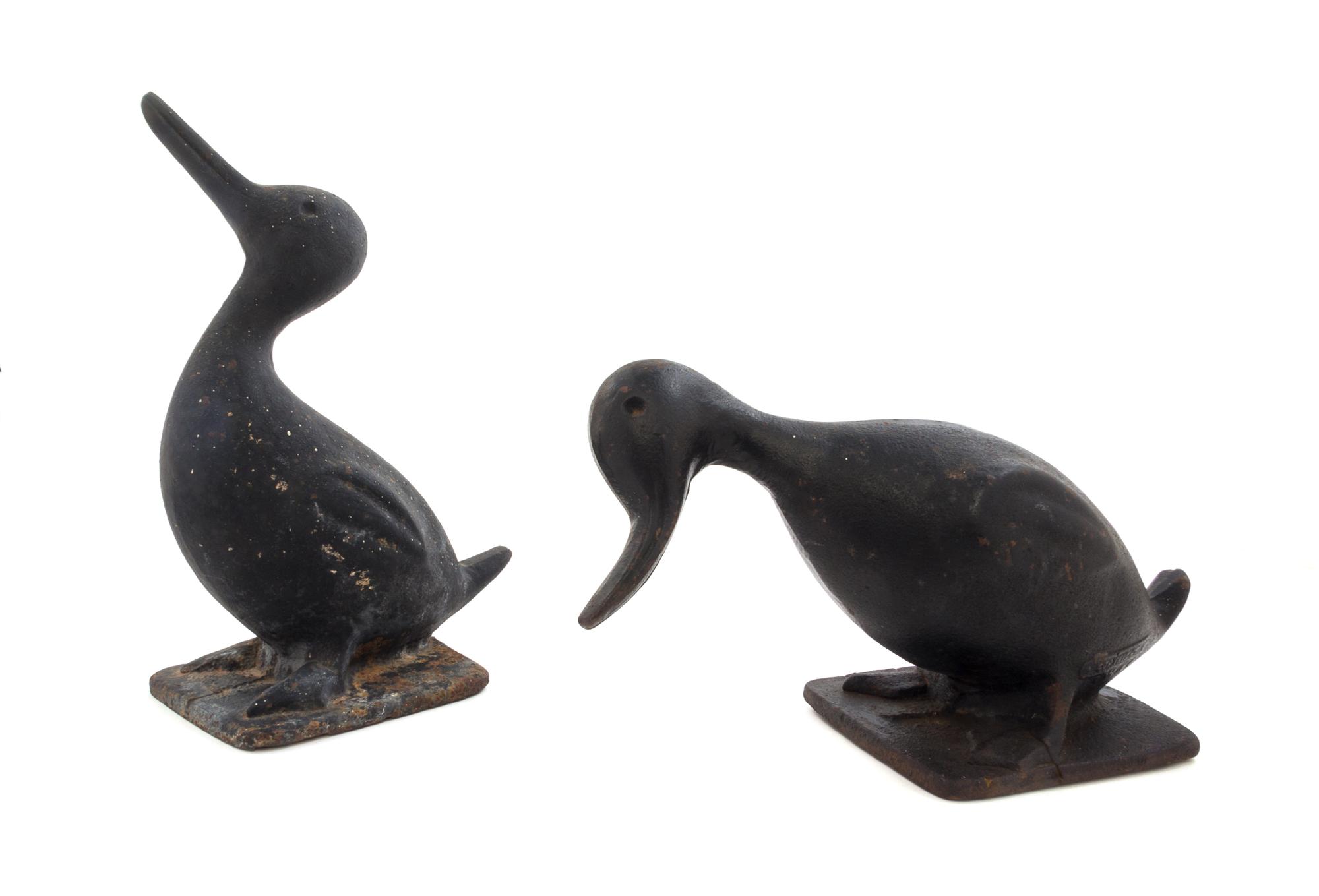Two Cast Iron Doorstops Height of tallest 11 1/2 inches.