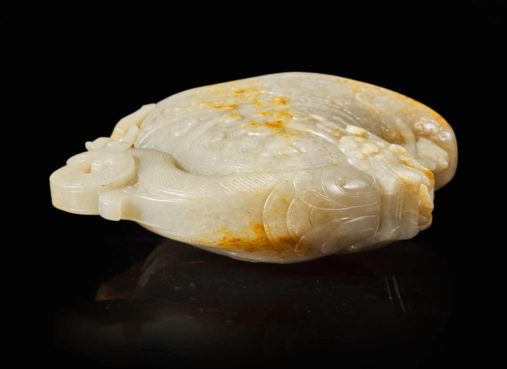 A large Chinese carved pale celadon and russet jade rhyton vessel 青白玉雕觥杯