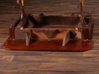 A Classical Parcel Gilt and Ebonized, Figured Mahogany Paw-Foot Drop-Leaf Table