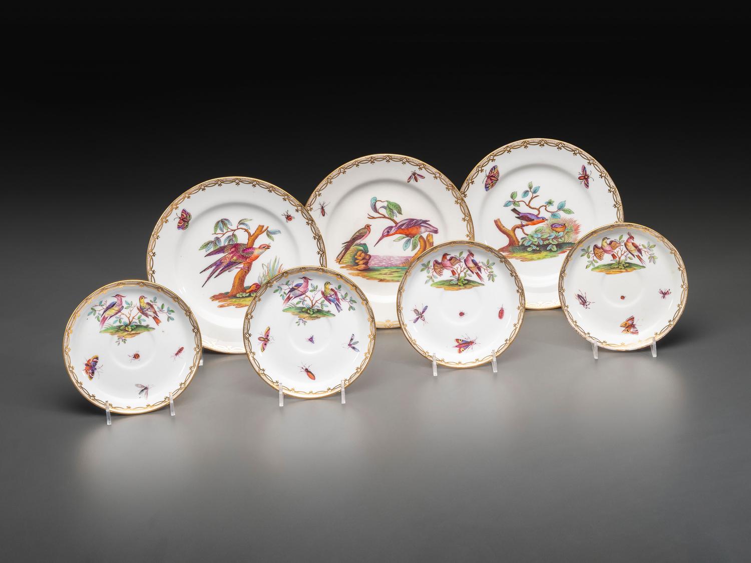 An English Parcel Gilt Bird and Insect Decorated Porcelain Partial Dinner Service