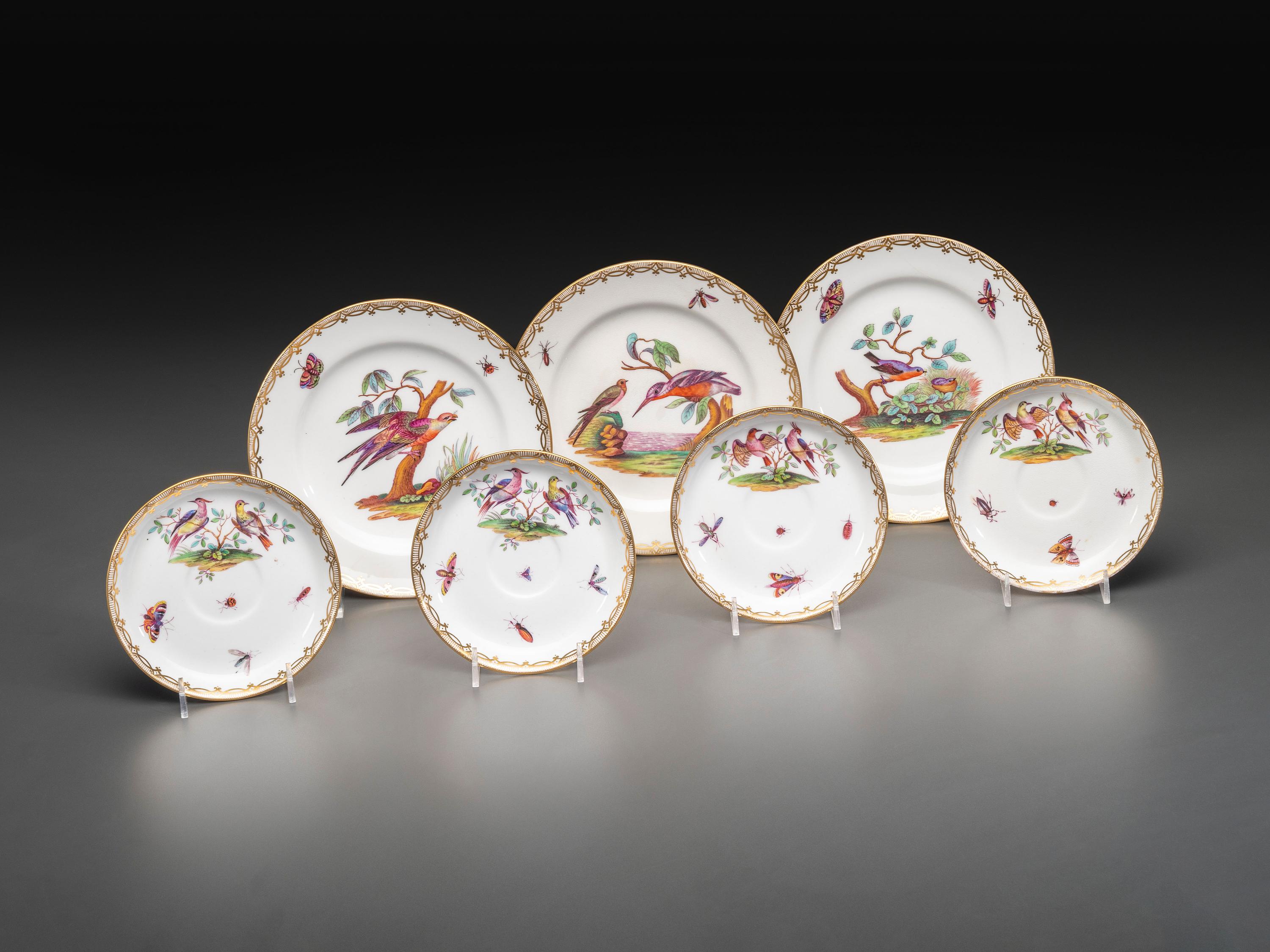 An English Parcel Gilt Bird and Insect Decorated Porcelain Partial Dinner Service