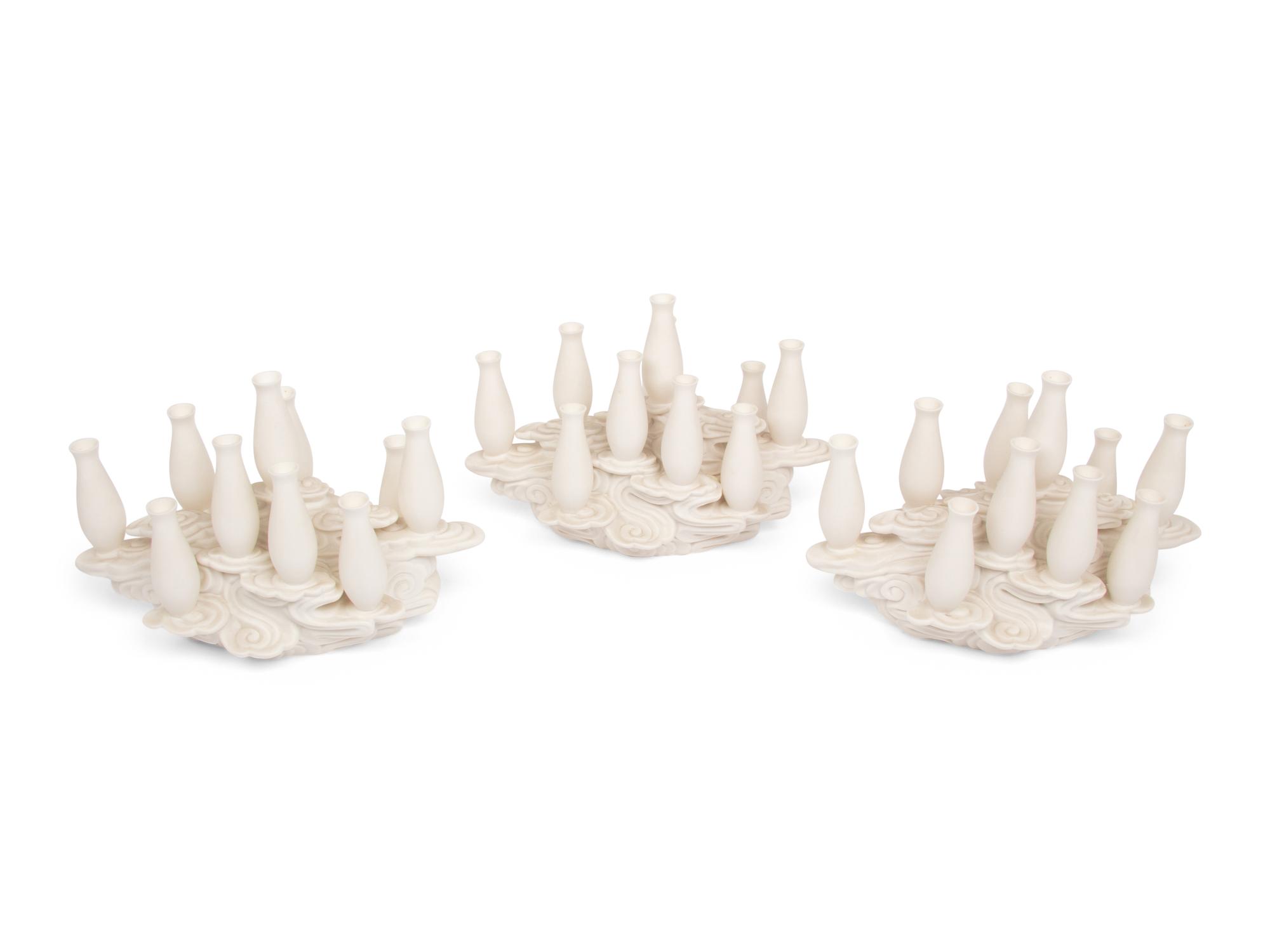 A Set of Three Contemporary Bisque Porcelain Candelabra