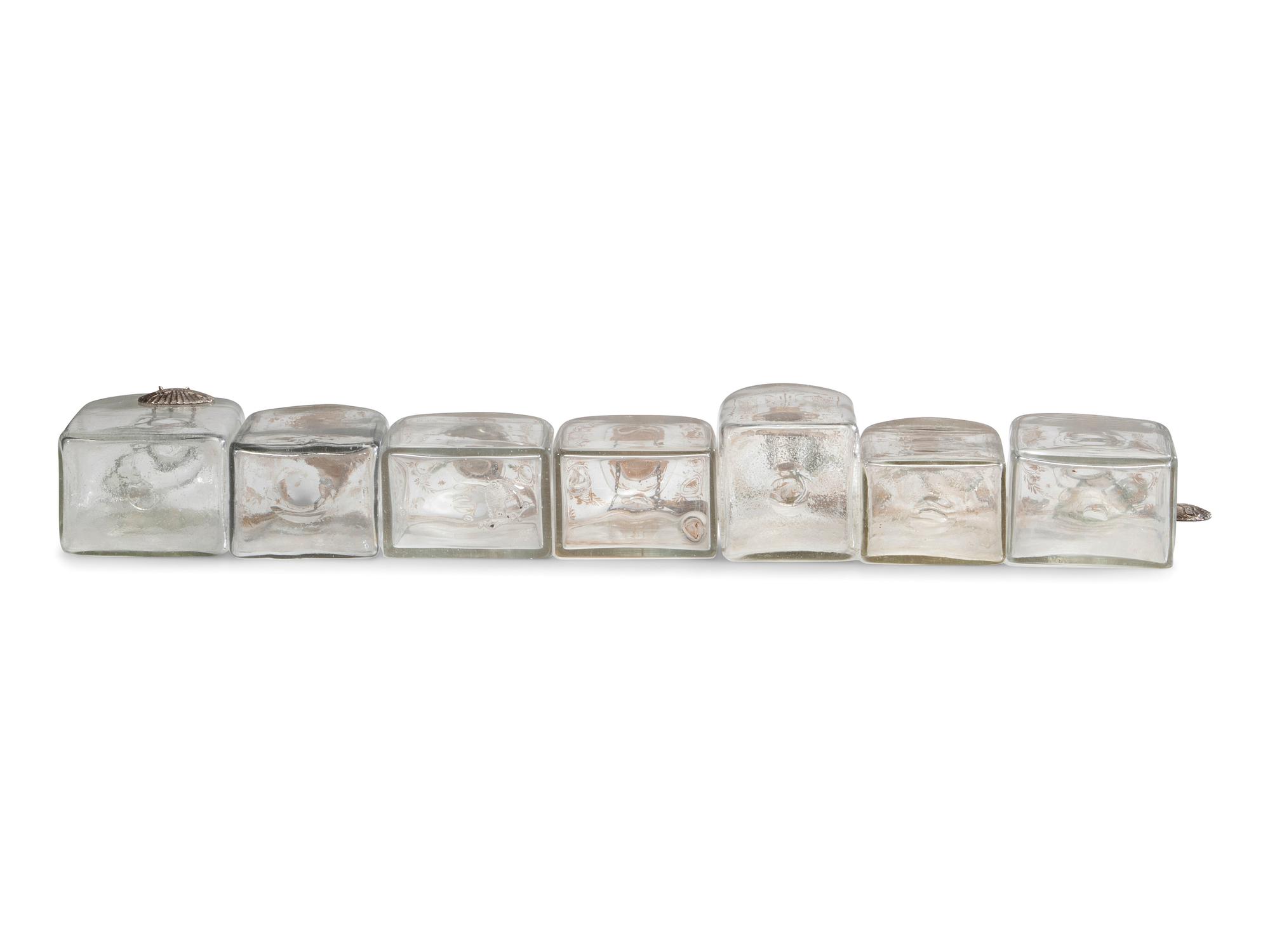 Fifteen Glass Decanters with English Shell-Form Silver Bottle Tags