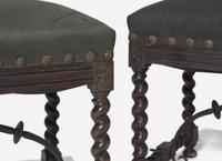 A Pair of Spanish Baroque Style Stained Beechwood and Wrought Iron Stools