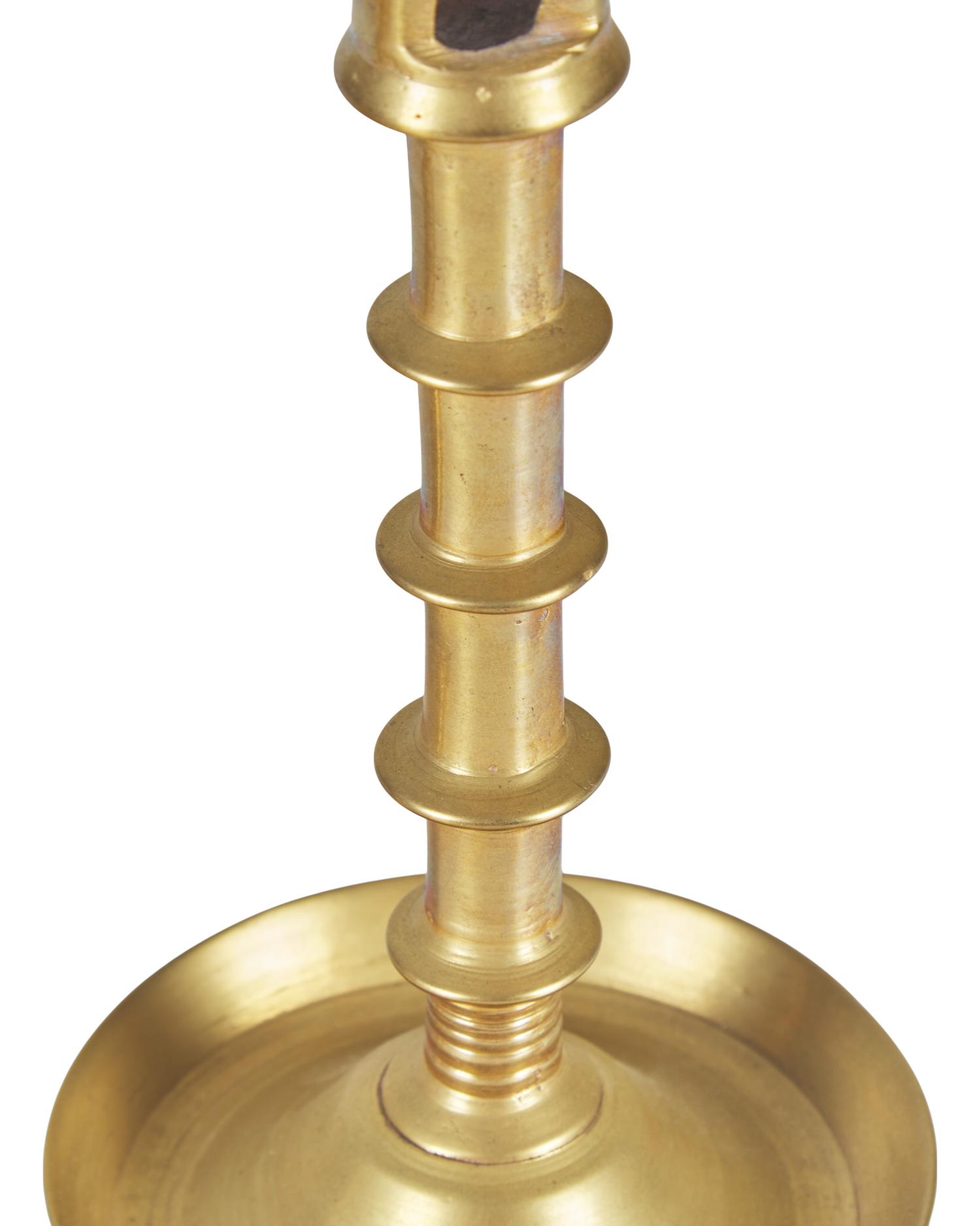 A Group of Three Flemish Brass Candlesticks