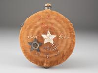 [CIVIL WAR]. A group of 3 items identified to George J. Putney, Company E, 29th Ohio Infantry, comprised of a silver corps badge engraved with battle honors, embellished canteen, and book taken from wreckage at Bristoe Station.