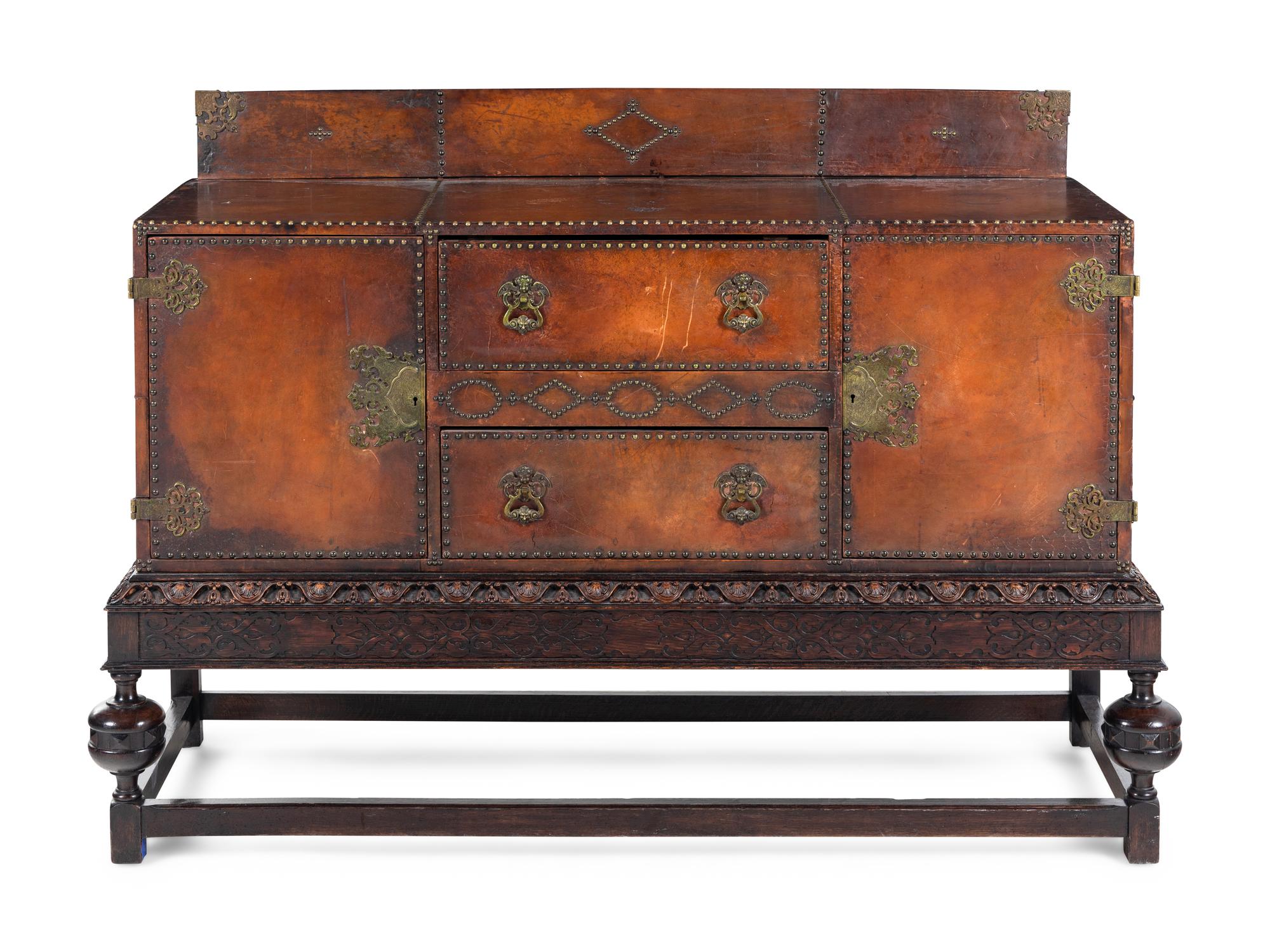 A Spanish Baroque Style Leather-Veneered Side Cabinet
