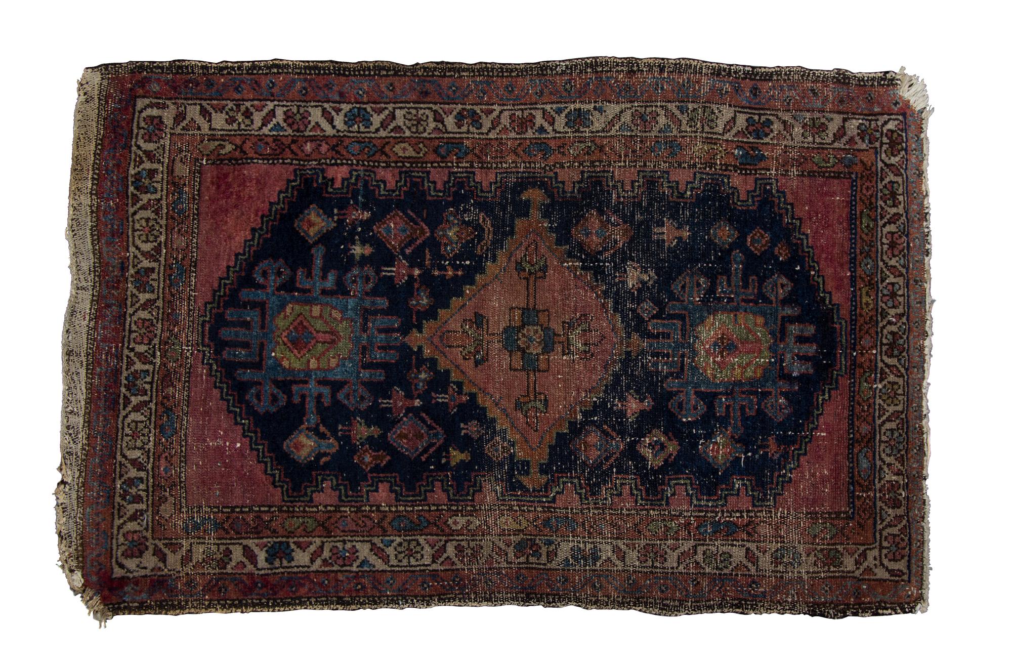 A Persian Wool Rug 3 feet 11 inches x 2 feet 6 1/2 inches.