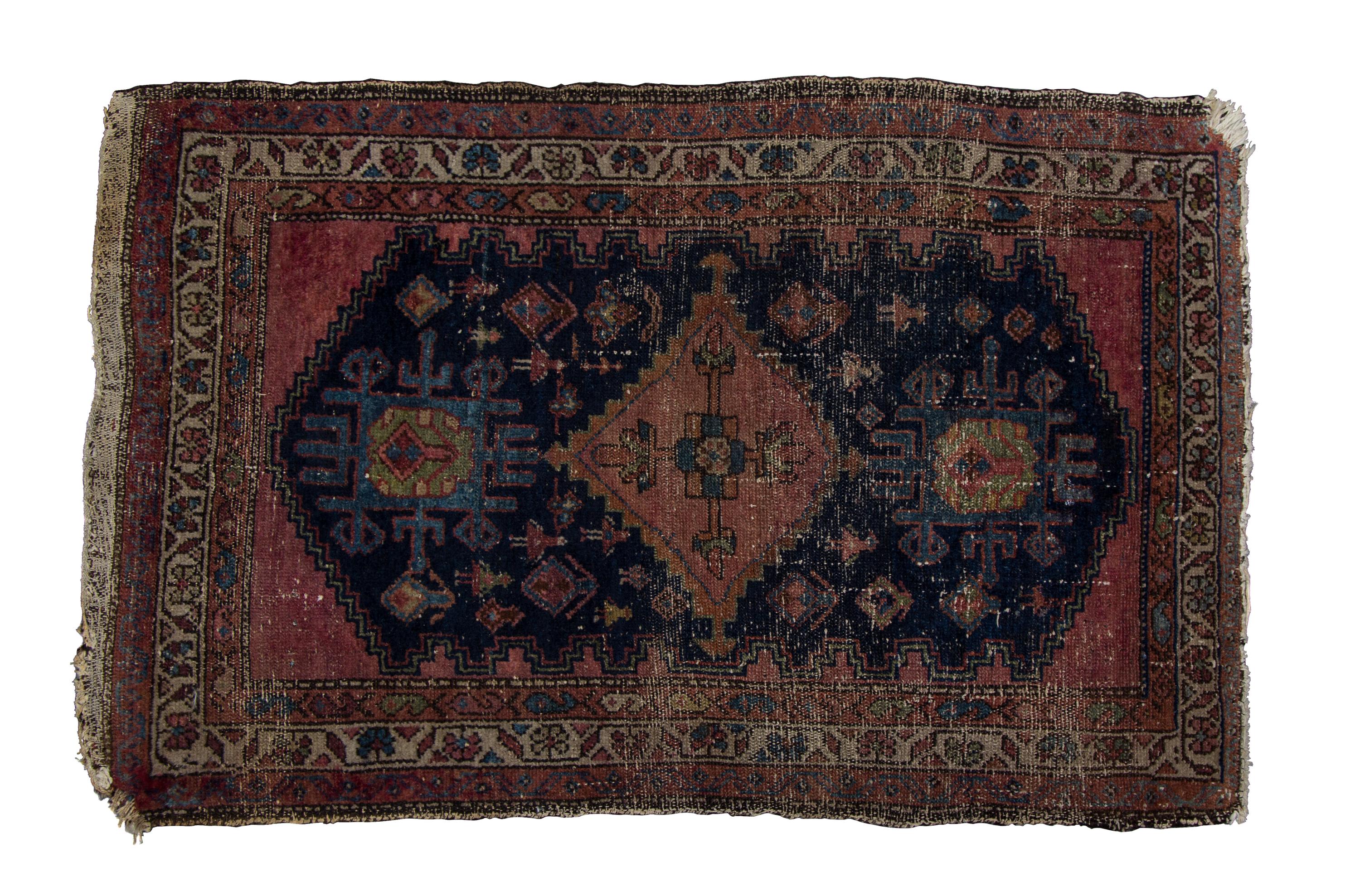 A Persian Wool Rug 3 feet 11 inches x 2 feet 6 1/2 inches.