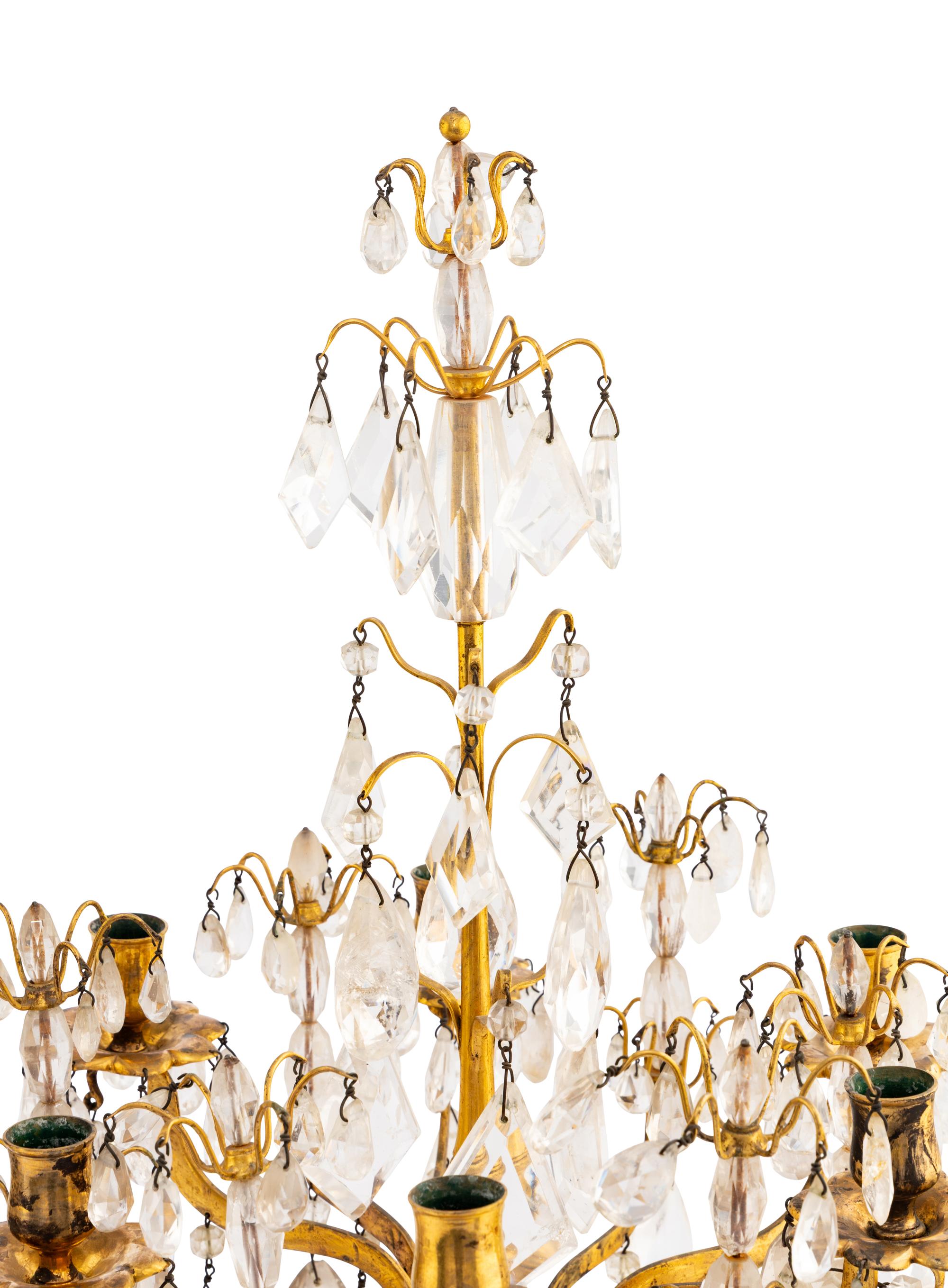 A Pair of Régence Style Rock Crystal, Cut Glass and Engraved Gilt Bronze Six-Light Candelabra on Simulated Porphyry Bases