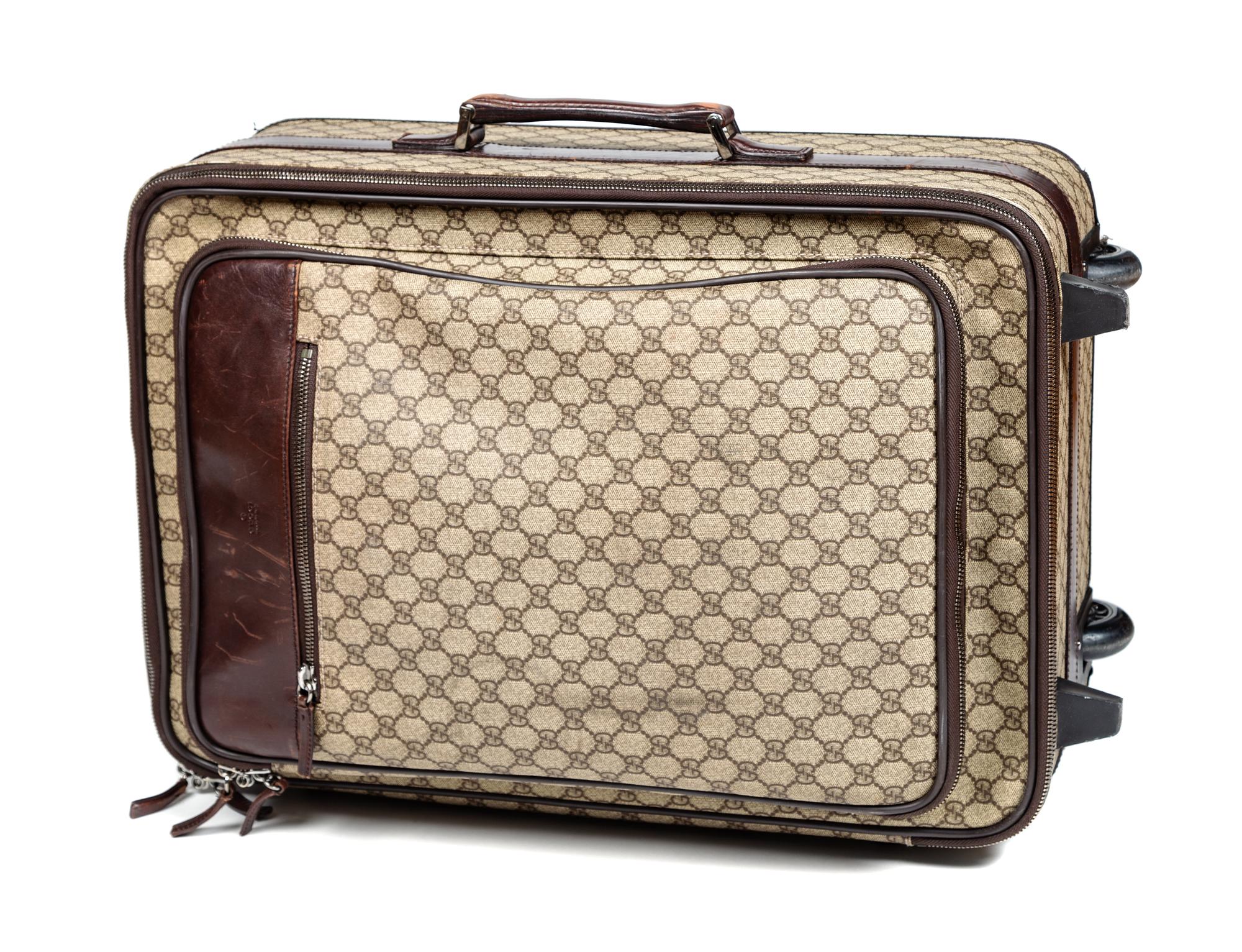 A Gucci Monogram Canvas Roller Suitcase, 22" H x 15.25" W x 9.25" D; Handle: 1.25".