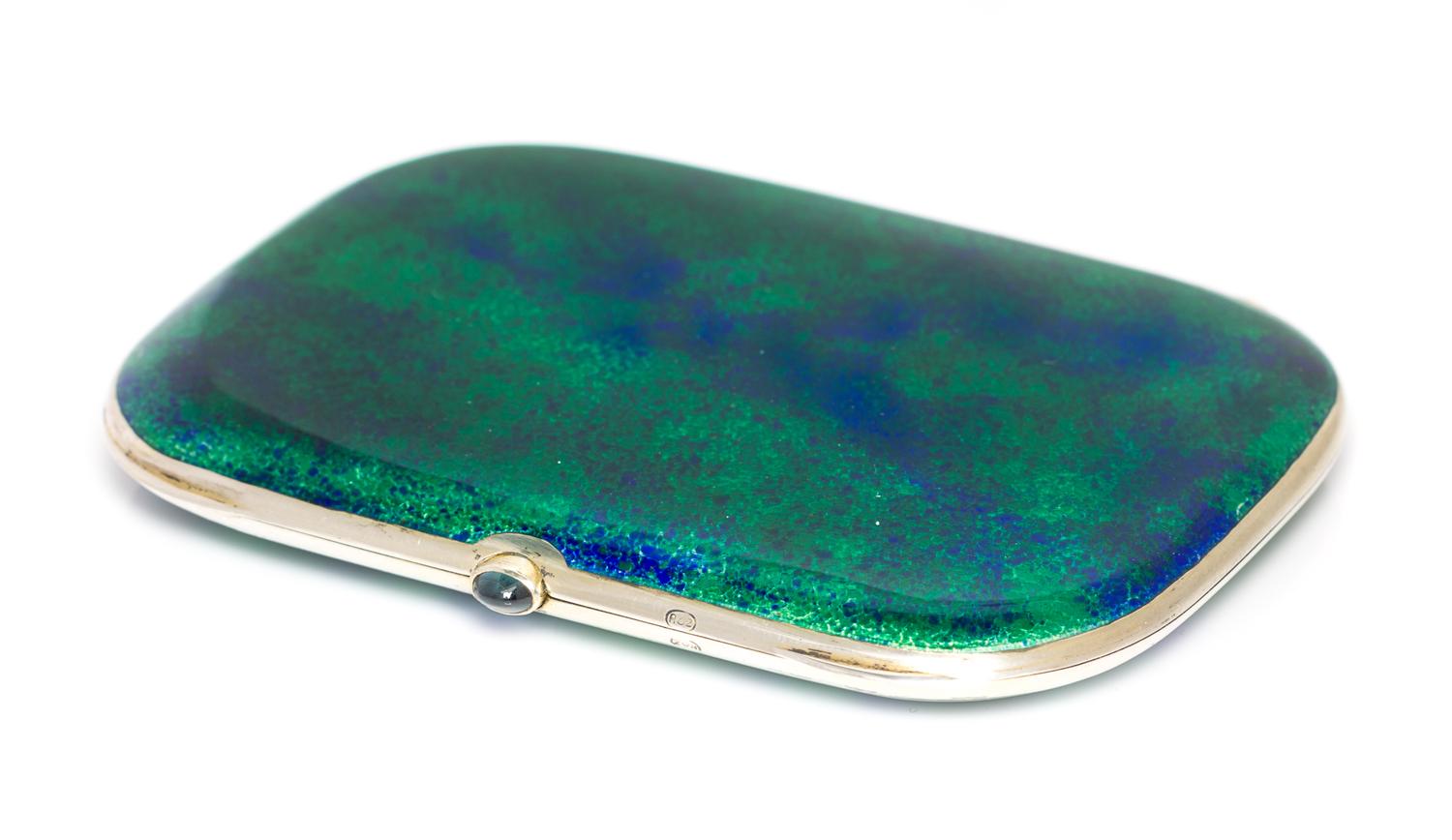 A Silver and Enamel Cigarette Case, Maker's Mark ROZ, the case having a blue and green paillonne enamel finish.