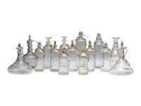 Fifteen Glass Decanters with English Shell-Form Silver Bottle Tags