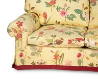 A Yellow Floral Chintz Upholstered Sofa and a Pair of Matching Drapes