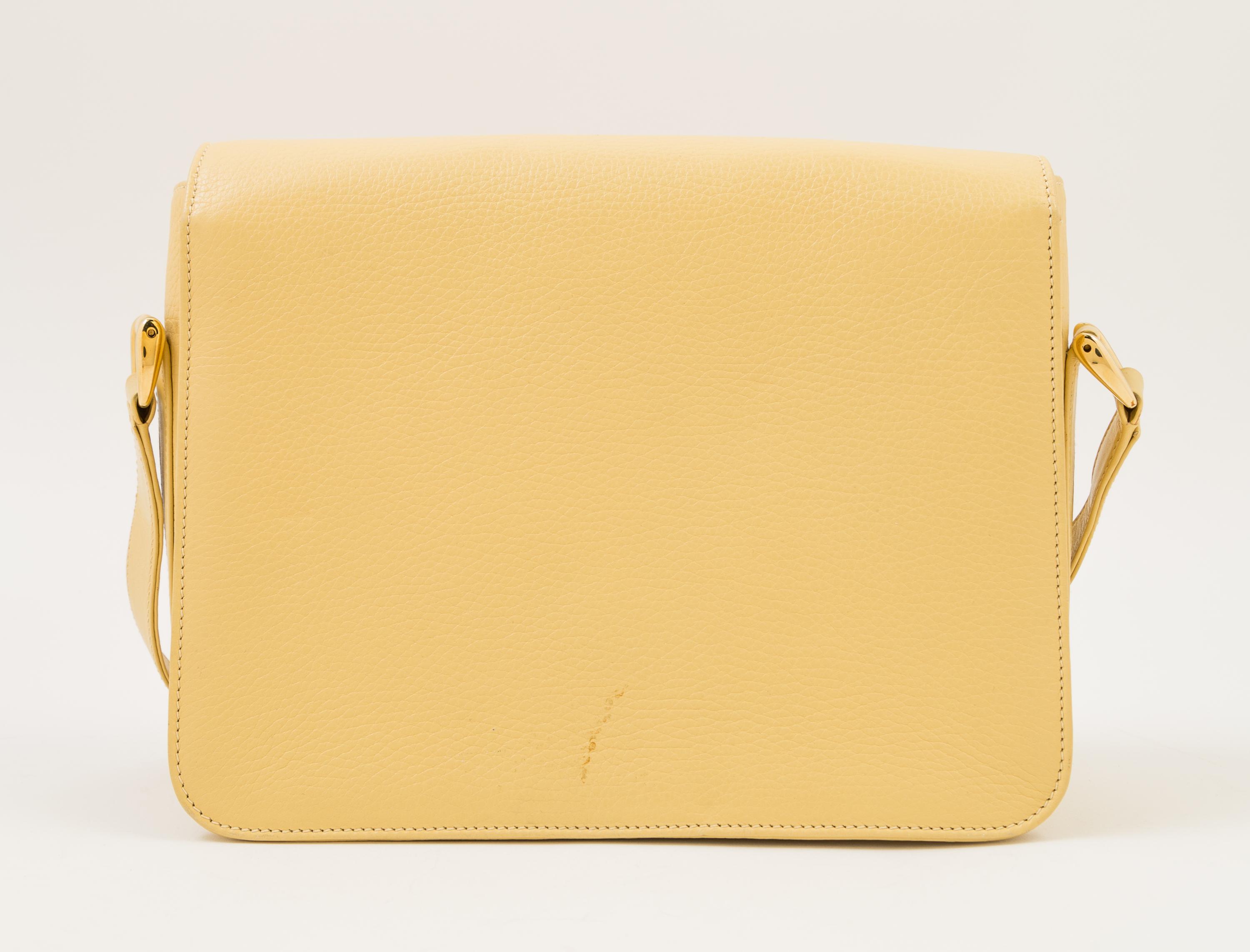 A Gucci Pale Yellow Leather Flap Handbag, 10" x 8" x 3"; Strap drop: 20".