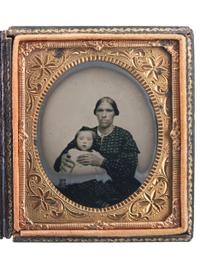 [EARLY PHOTOGRAPHY]. Sixth plate ruby ambrotype of an African American or mixed race woman holding a white child.