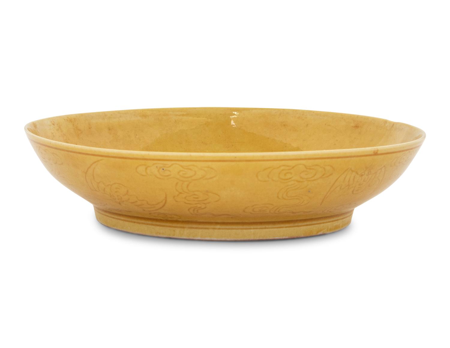 An Incised Yellow Glazed Porcelain 'Cranes and Pines' Plate