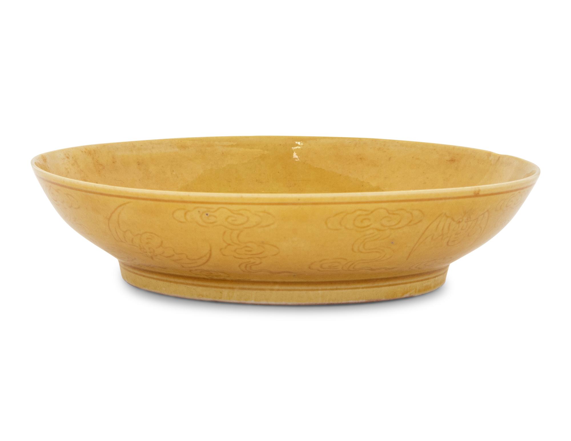 An Incised Yellow Glazed Porcelain 'Cranes and Pines' Plate