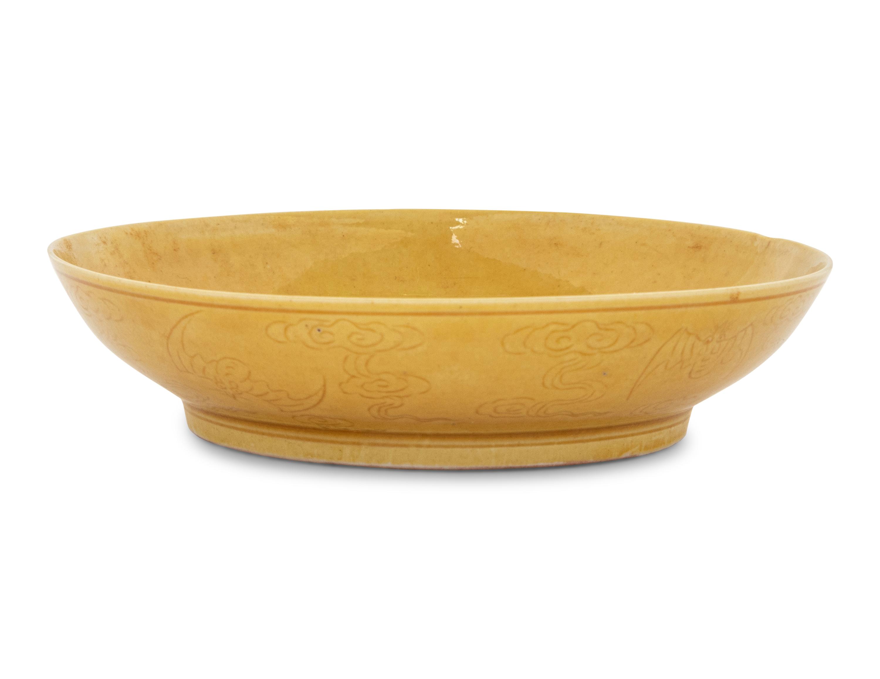 An Incised Yellow Glazed Porcelain 'Cranes and Pines' Plate
