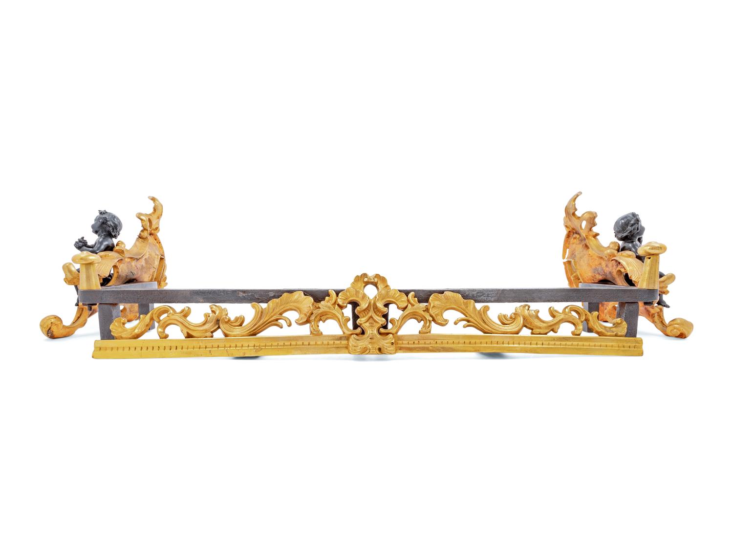 A Pair of French Gilt and Patinated Bronze Figural Chenets and Fender