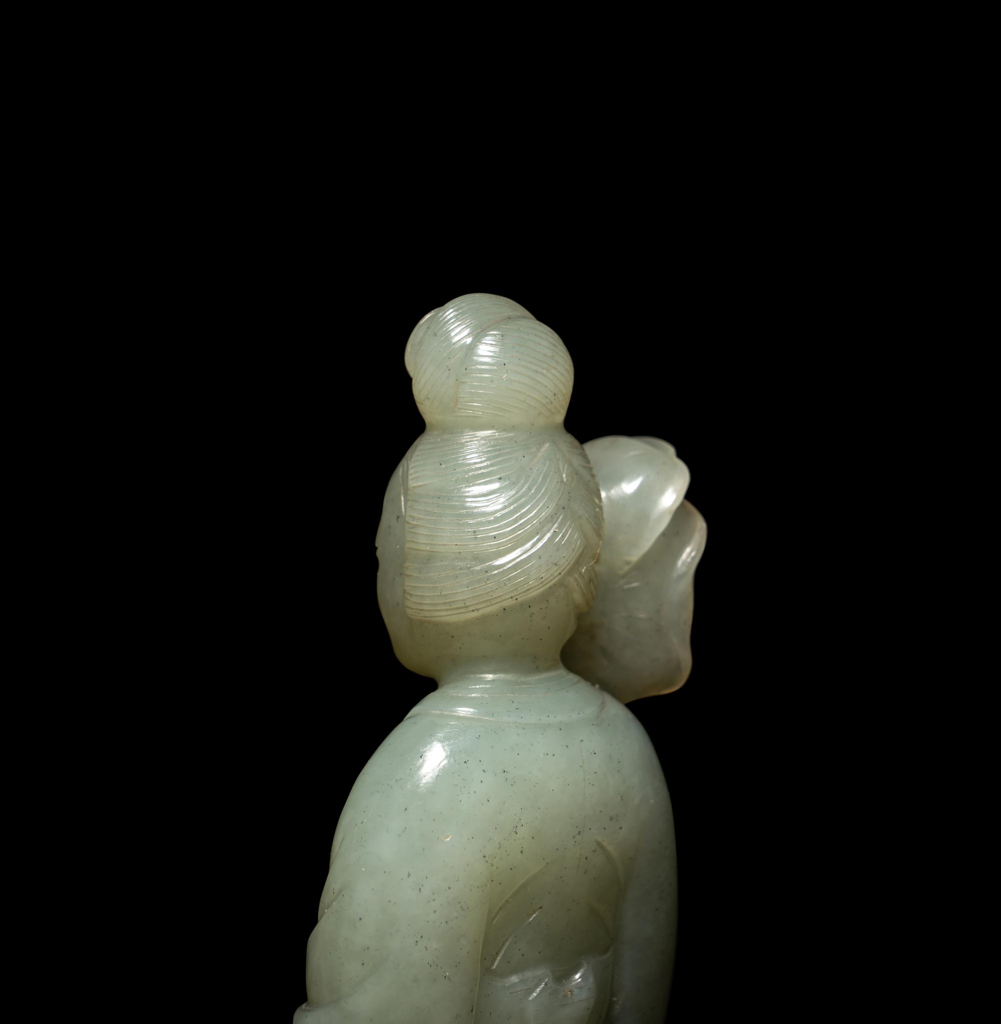 A Chinese Carved Pale Celadon Jade Standing Female Figure