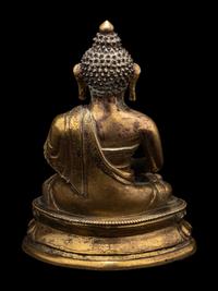 A Small Tibetan Gilt Bronze Figure of Medicine Buddha