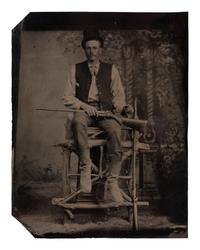 [EARLY PHOTOGRAPHY]. Tintype of man with a Colt revolving rifle and shotgun.