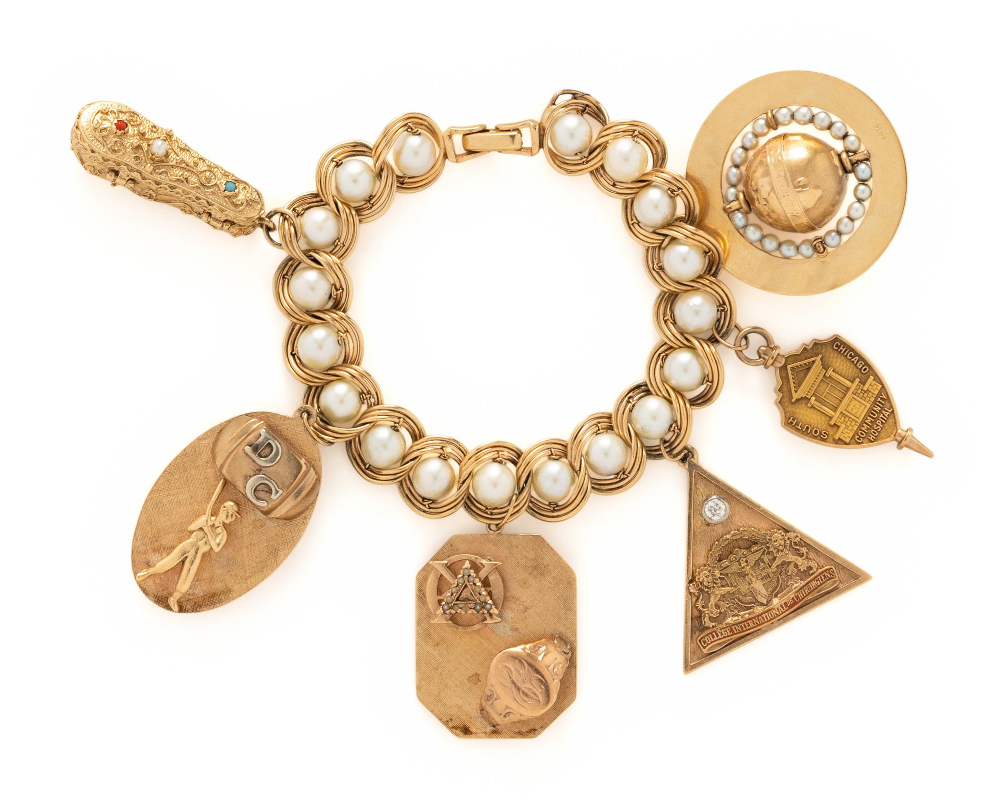 YELLOW GOLD CHARM BRACELET AND TWO CHARMS