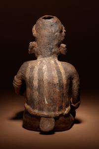 A Nayarit Terracotta Crouching Figure with Vessel