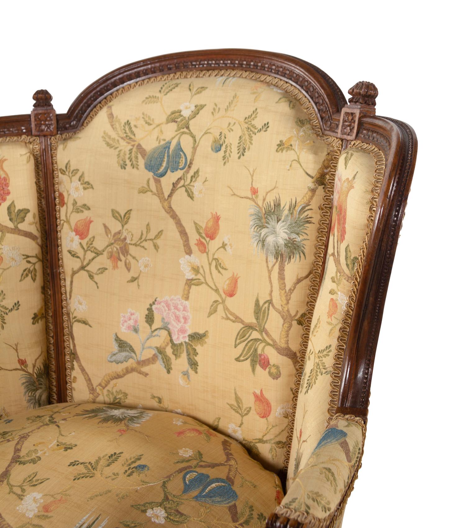 A Pair of Louis XVI Style Carved Walnut Bergères