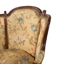 A Pair of Louis XVI Style Carved Walnut Bergères