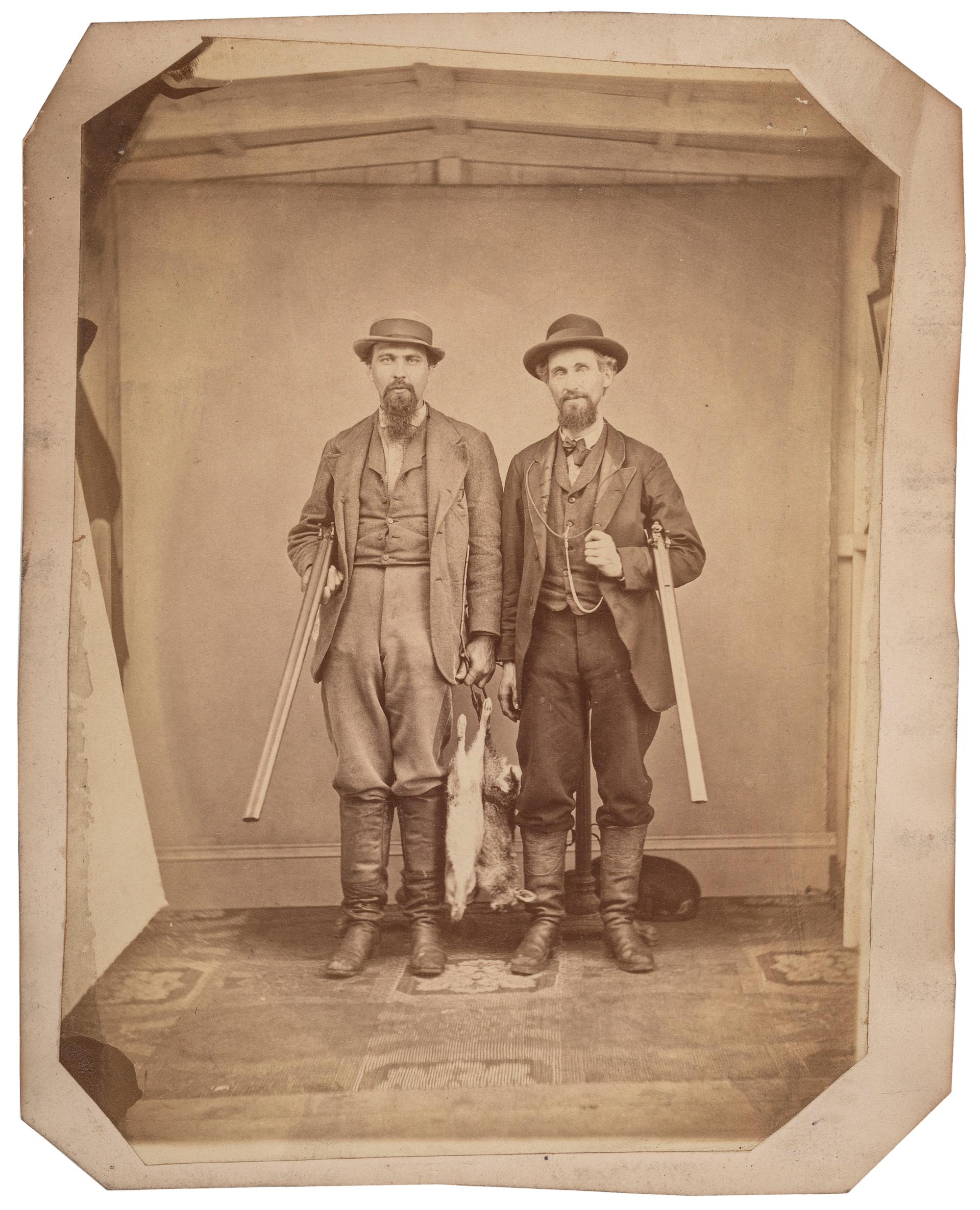 [EARLY PHOTOGRAPHY]. Large format albumen photograph of two armed hunters posed with their game. N.p.: n.p., n.d.