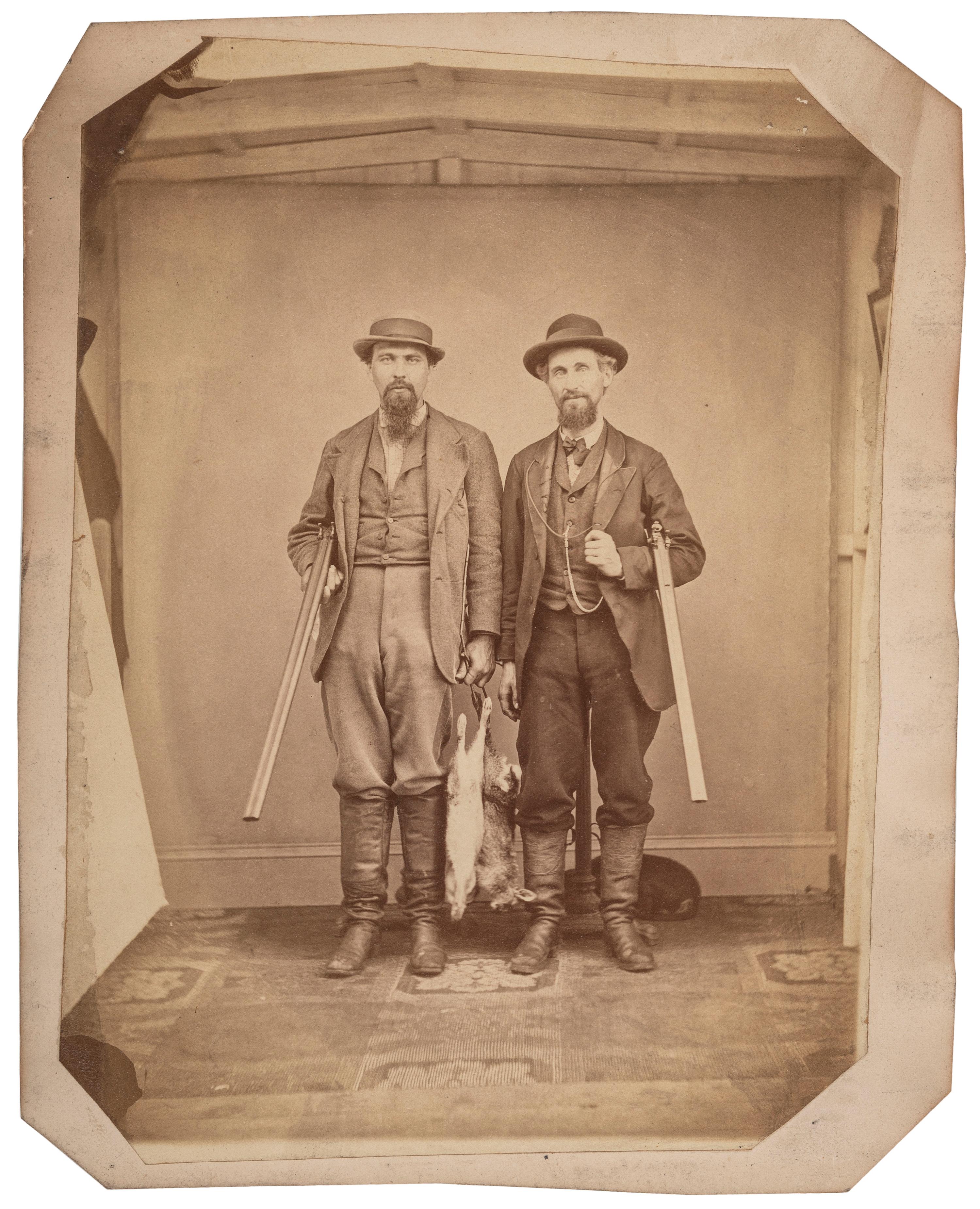 [EARLY PHOTOGRAPHY]. Large format albumen photograph of two armed hunters posed with their game. N.p.: n.p., n.d.