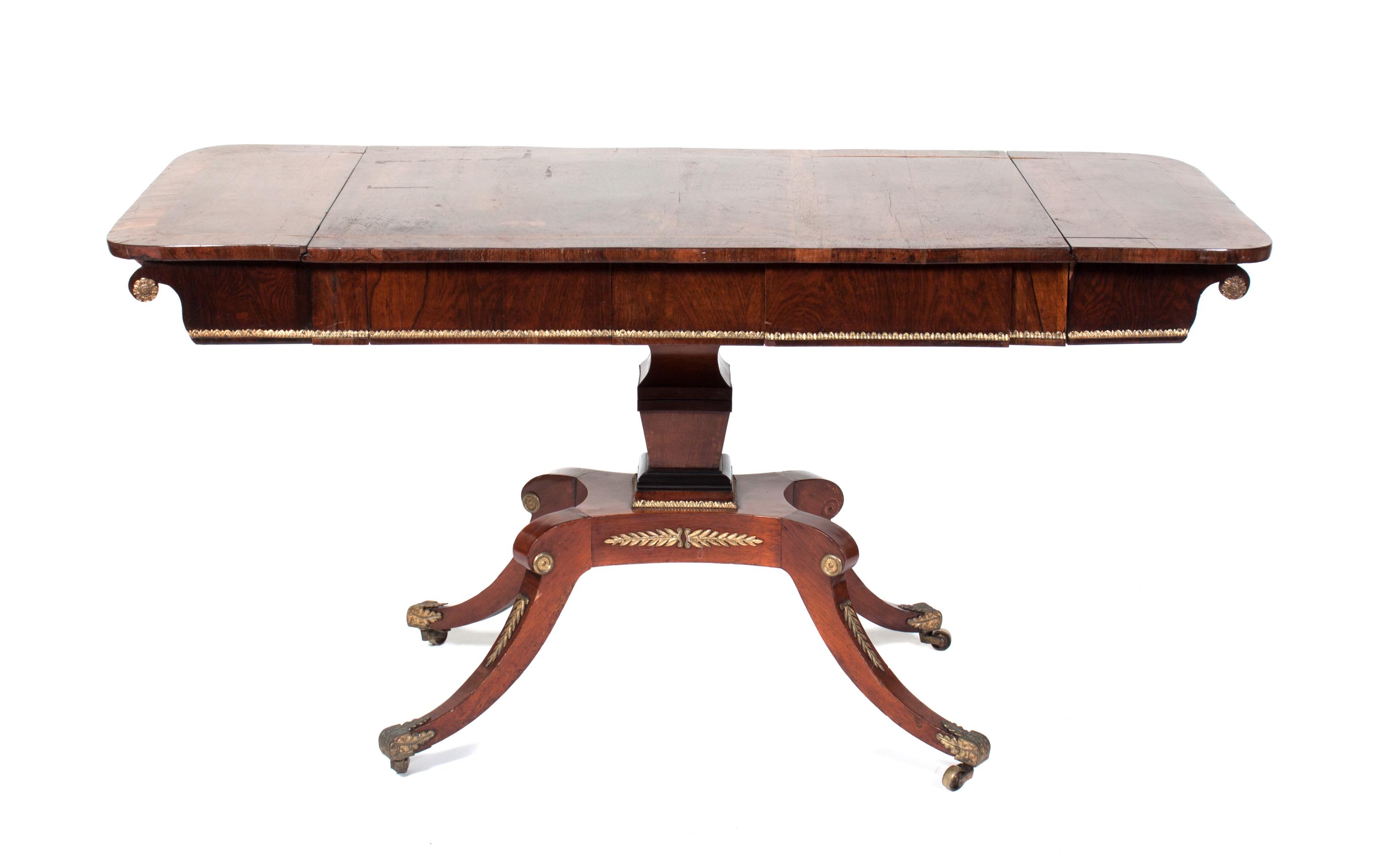A Regency Gilt Metal Mounted Rosewood Sofa Table Height 27 3/4 x width 54 1/2 x depth 24 3/4 inches.